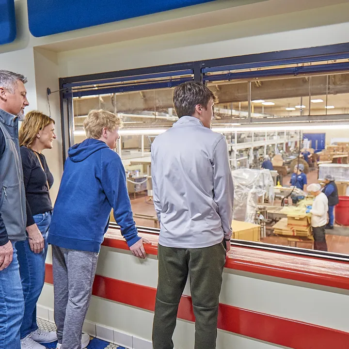 Family viewing the Herr's snack factory on a tour