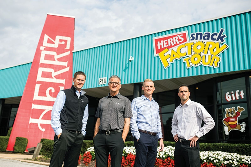 Herr's 3rd Generation leaders in front of the Herr's Snack Factory