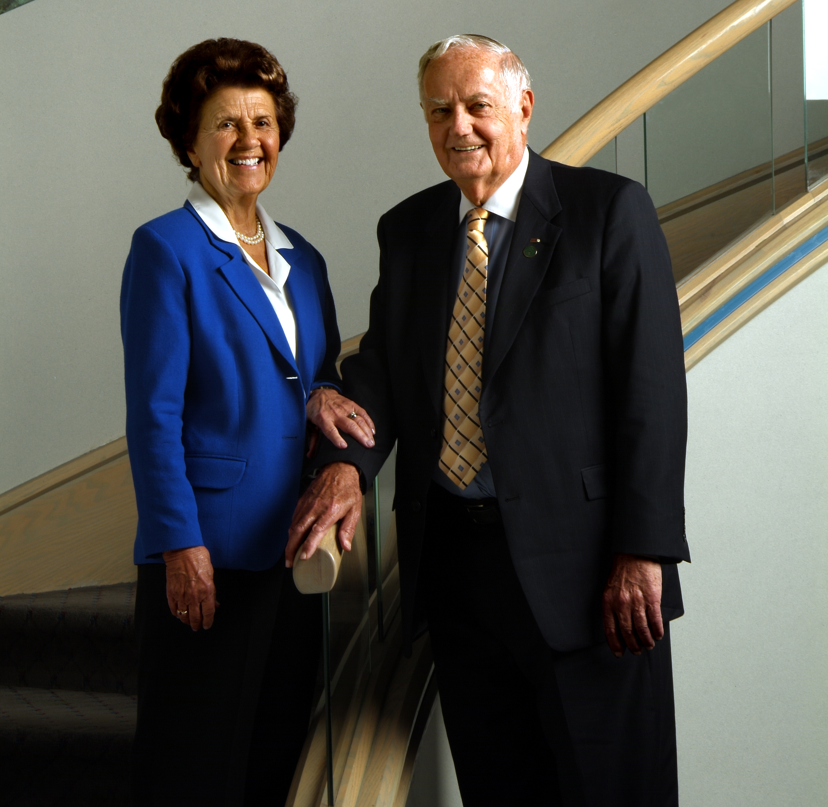 James S. Herr and Miriam Herr posing for a photo on a spiral staircase